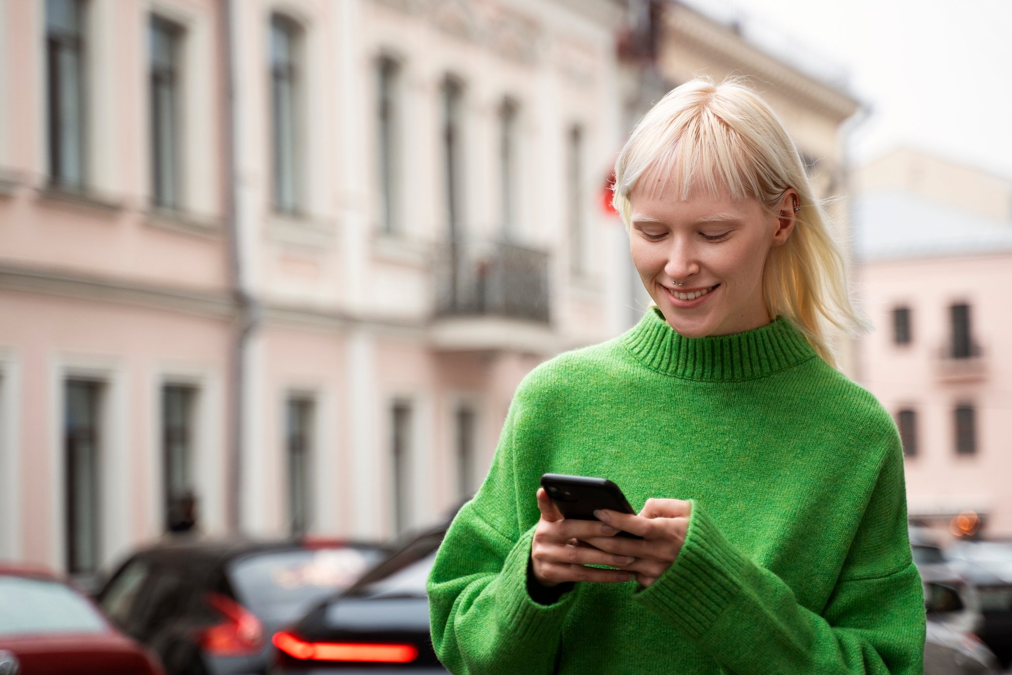medium-shot-albino-woman-holding-smartphone